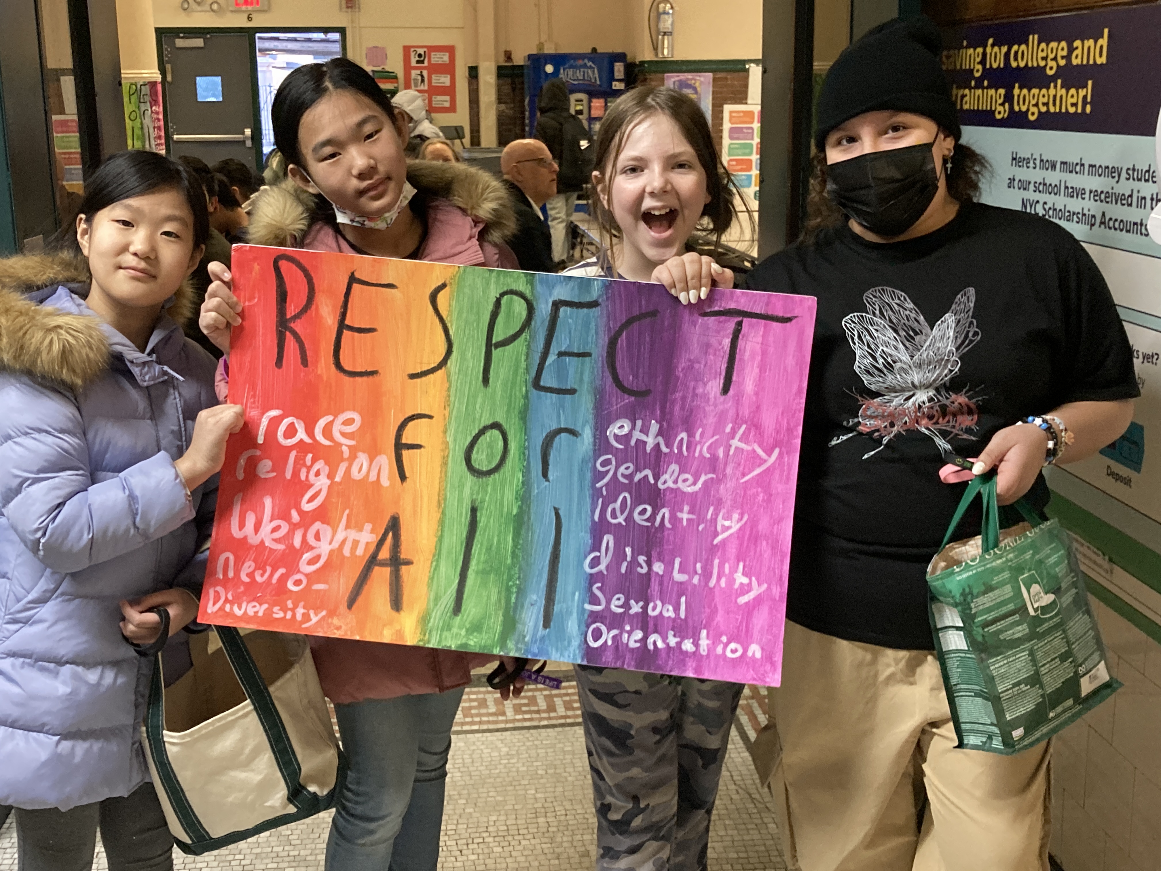students holding a respect poster